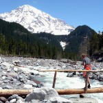 A hiker crosses the Nisqually on the bridge near Cougar Rock. Paradise River Karen S